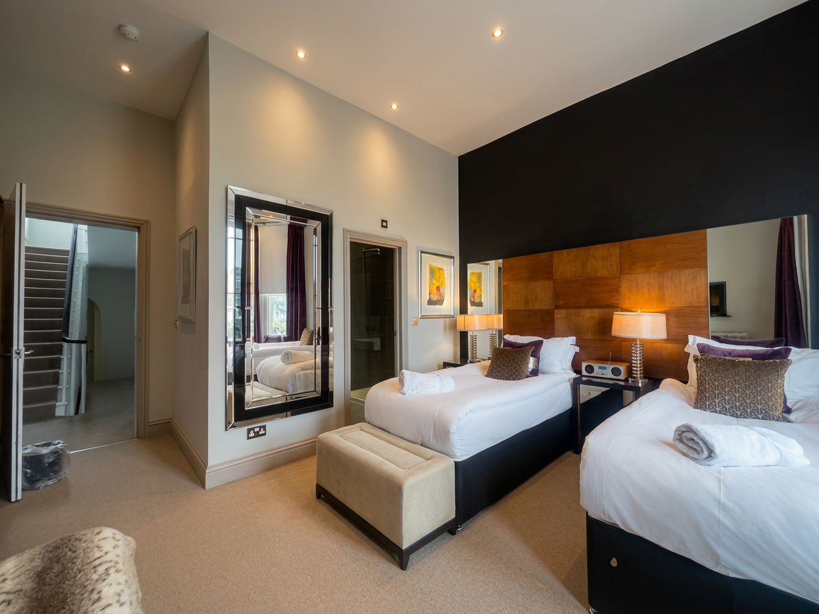 Hastings House Bedroom 3 — wide angle showing twin beds and bay windows