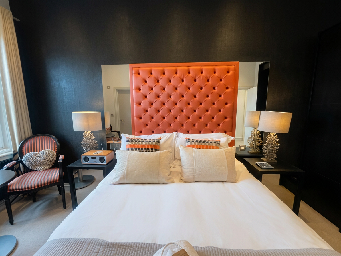 Hastings House Bedroom 6 — front-on view of orange headboard against dramatic dark wall